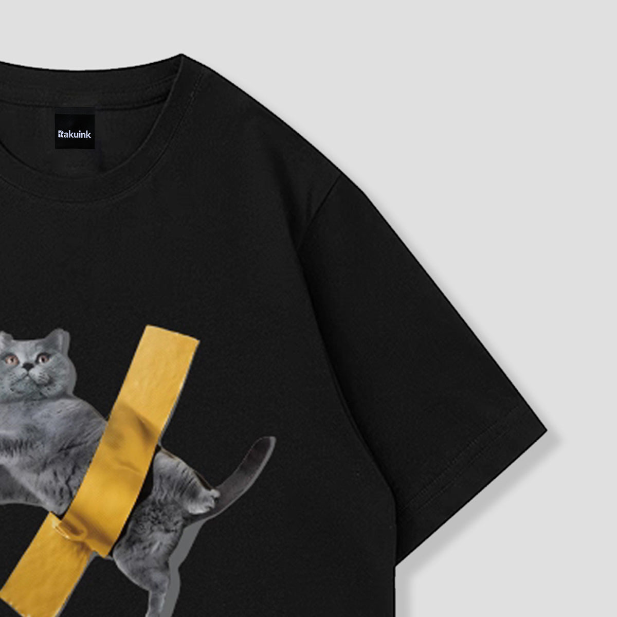 黒い半袖Tシャツ、猫と黄色テープ柄プリントの一部